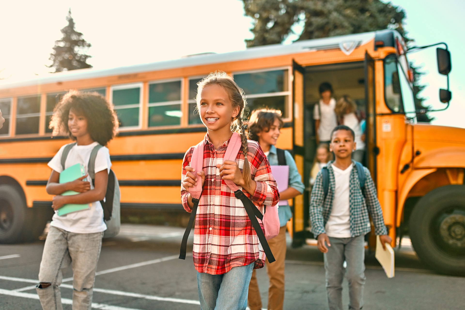 Children boarding a yellow school bus on a bright morning. Children boarding a yellow school bus on a bright morning.