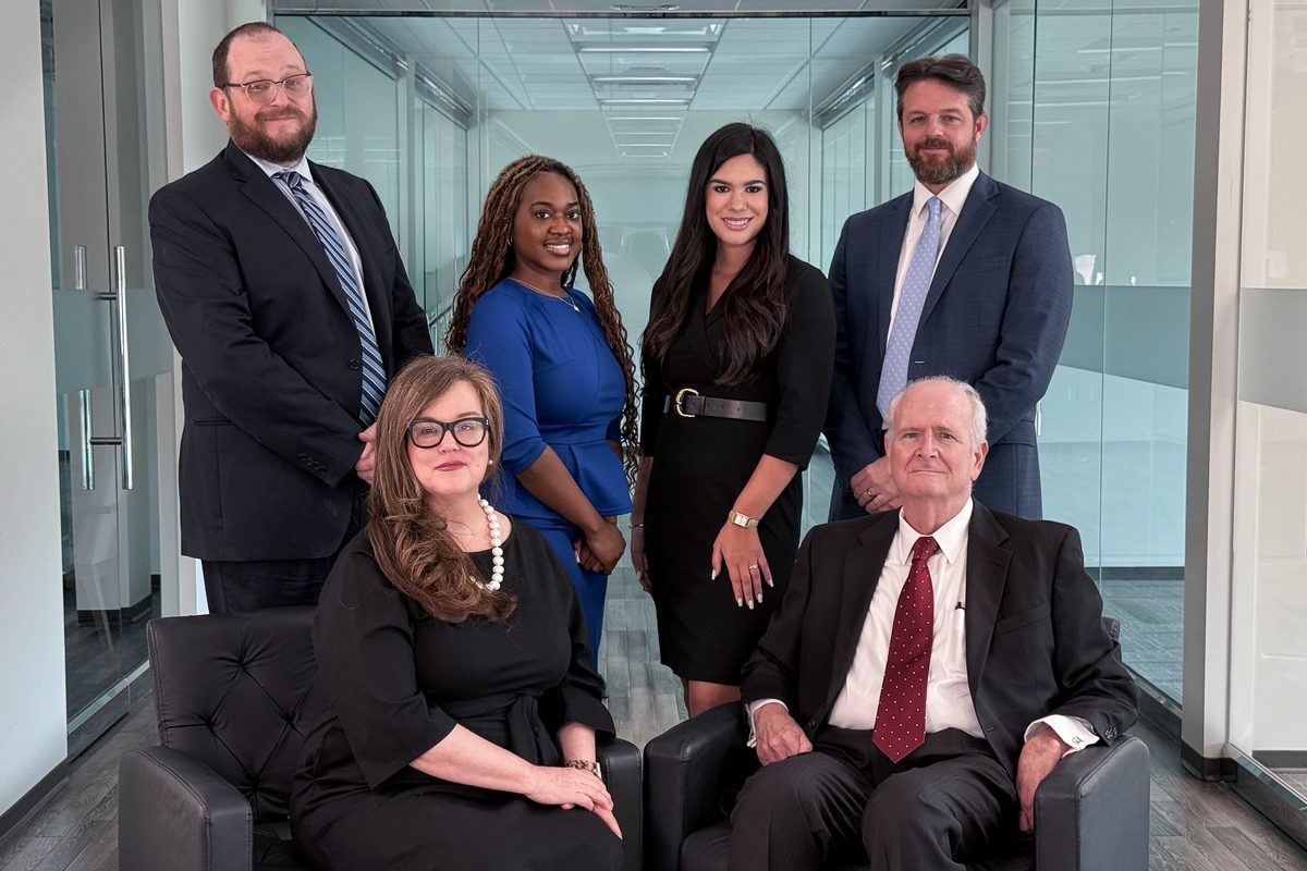 The attorneys of Griffin & Cain, Attorneys at Law, photographed together in the firm's Conroe office.