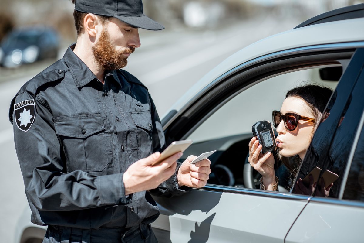 Driver taking a roadside breath test during a Texas DWI investigation