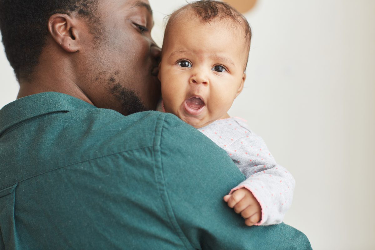 Father holding his infant child at home in Texas