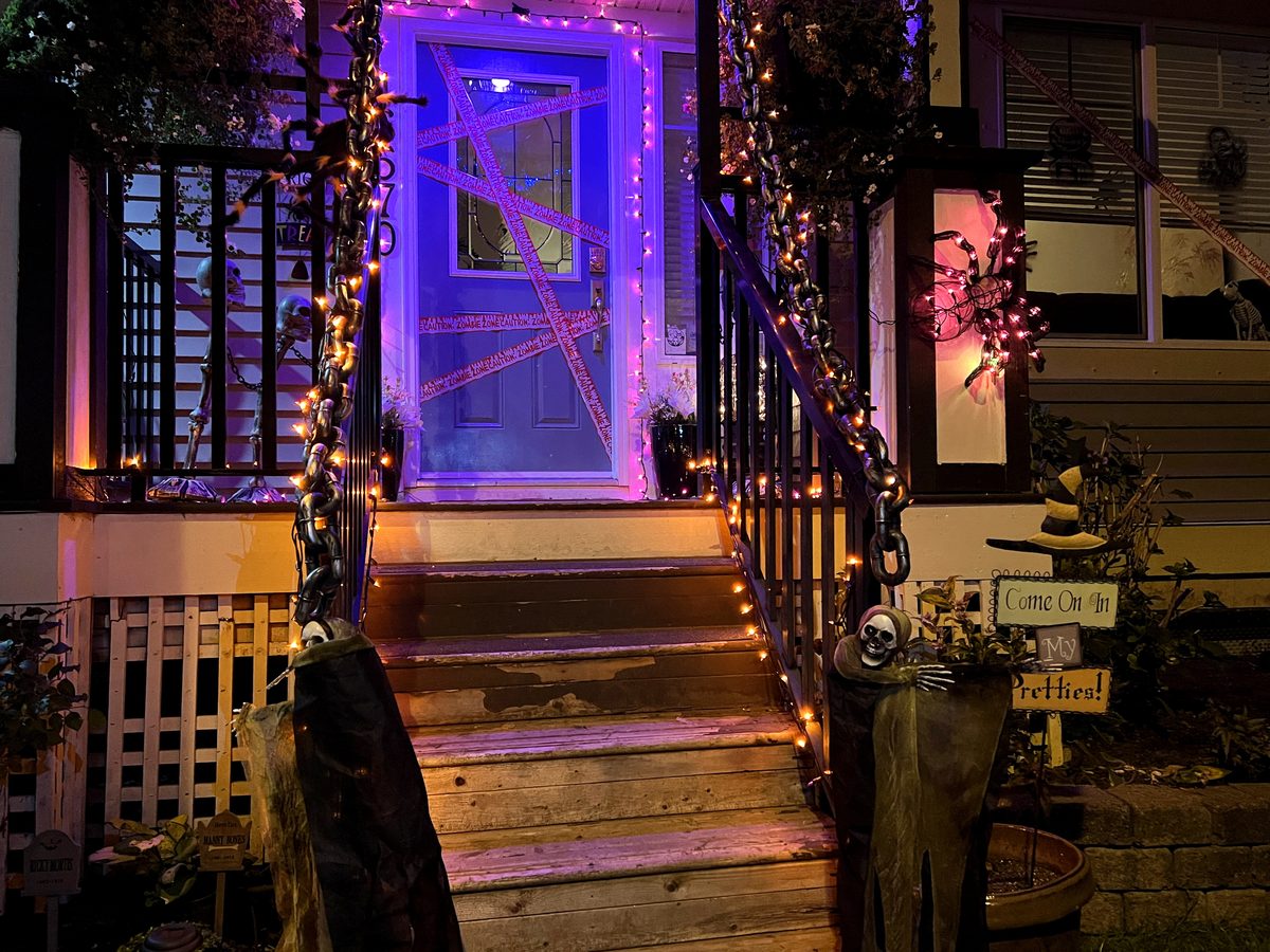 Halloween-decorated home lit up at night in a Texas neighborhood
