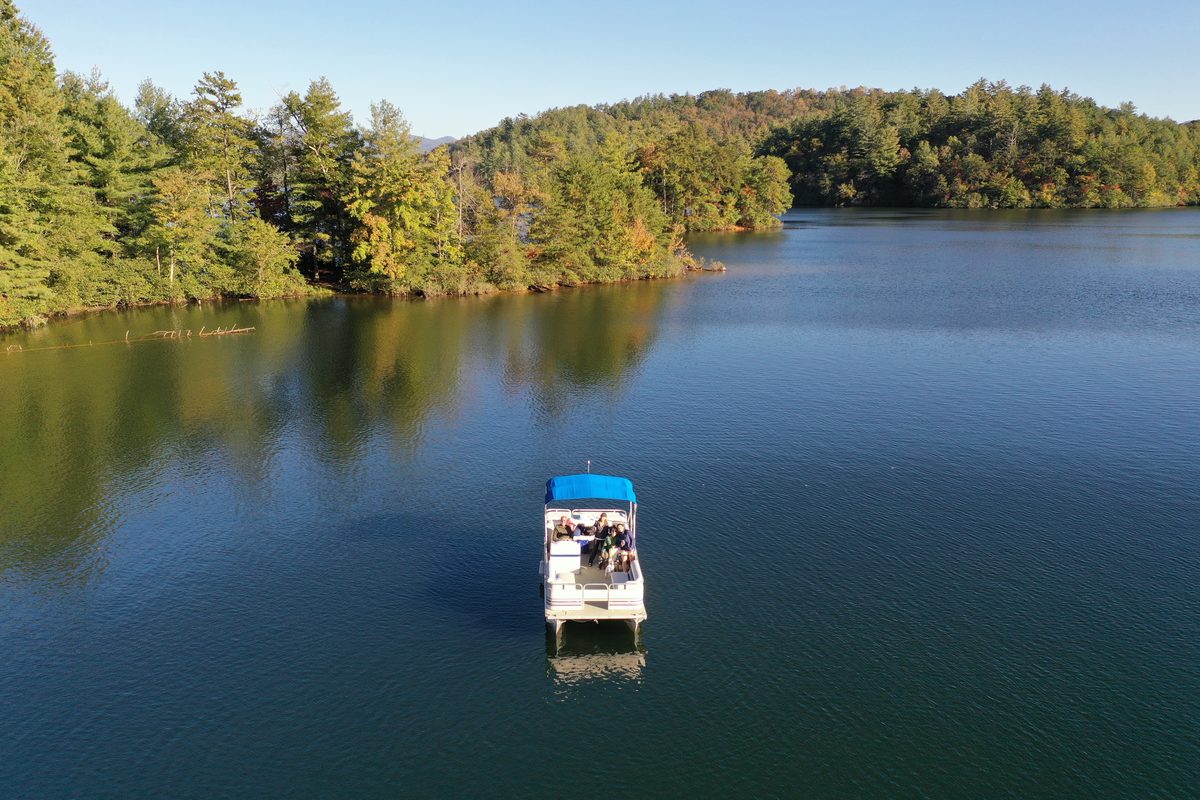 Pontoon boat on a wooded East Texas lake during Labor Day weekend